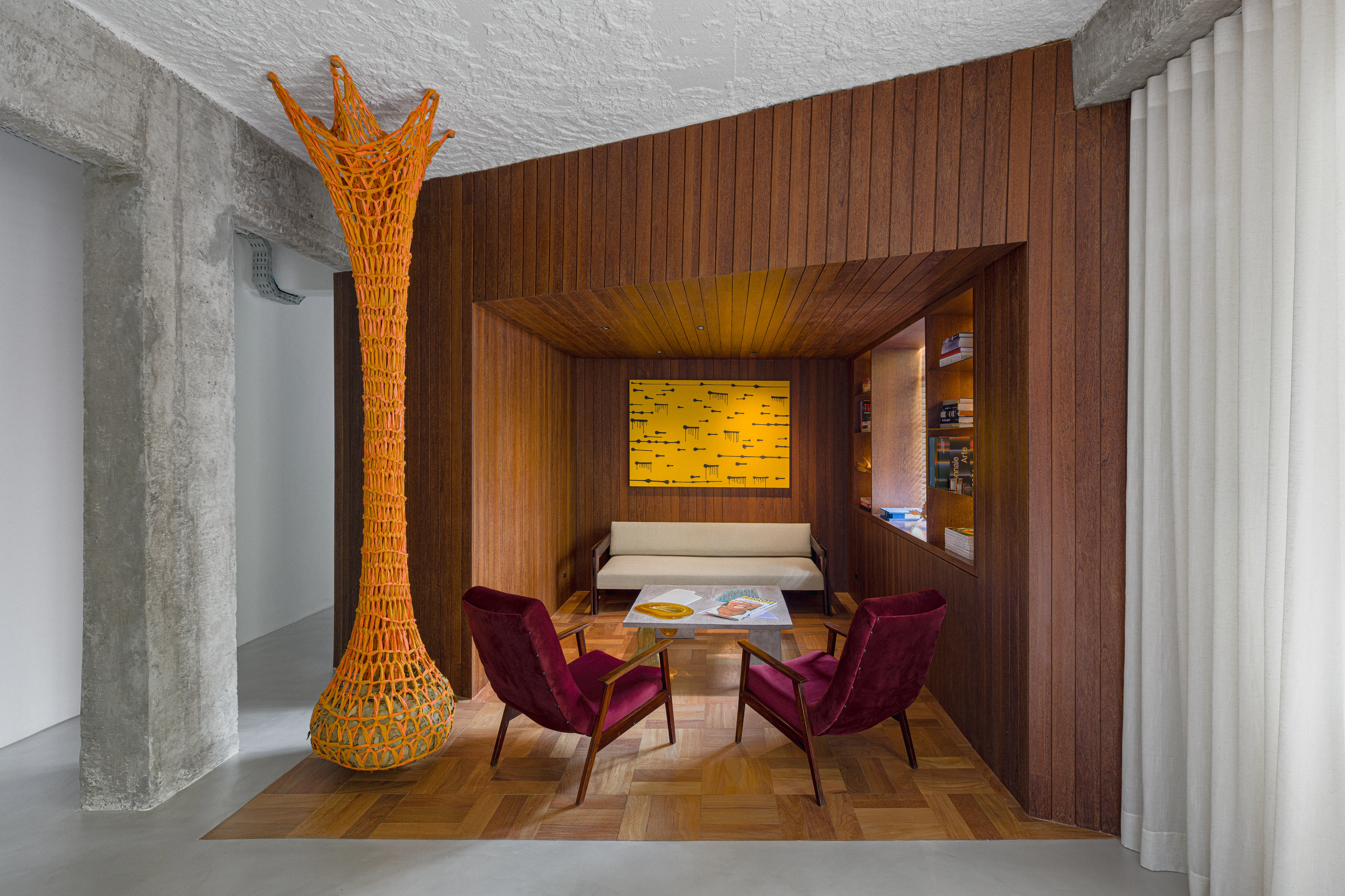 Elegant interior with wooden furniture and artwork, featuring modern and colorful sofas